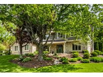 Charming two-story home featuring stone accents, well-maintained landscaping, and mature trees at 725 Sugarbush Dr, Zionsville, IN 46077
