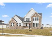 Two-story house with stone and white siding, a gray roof, and a grassy lawn at 12212 Tidecrest Dr, Fishers, IN 46037