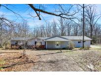 Charming ranch-style home featuring neutral siding, a covered entryway, and a well-maintained front yard on a sunny day at 7635 Grizzly Dr, Nineveh, IN 46164