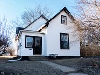 Charming two-story home with black trim, white siding, and a welcoming front entrance at 733 W 31St St, Indianapolis, IN 46208
