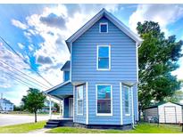 Two-story house with blue siding, front porch, and landscaping at 1011 S Elm St, Muncie, IN 47302