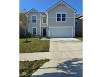 Charming two-story home with a well-maintained lawn and attached two car garage at 1331 Delacorte Cir, Shelbyville, IN 46176