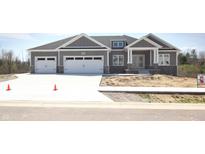 Charming gray home with a two car garage and beautiful stone accents at 3725 Maple Ridge Trl, Columbus, IN 47201