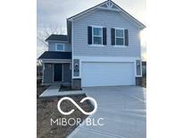 Two-story home with gray siding, attached garage, and walkway at 1033 Fuller Ln, Shelbyville, IN 46176