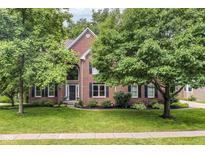 Charming brick two-story home with landscaped front yard and mature trees at 14626 Warner Trl, Westfield, IN 46074