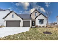 Charming brick home featuring a three car garage and well-manicured lawn at 4982 Reavie Ct, Noblesville, IN 46062