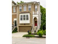 Charming two-story home with a brick and siding exterior, front-entry garage, and a red front door at 729 Greenford N Trl, Carmel, IN 46032