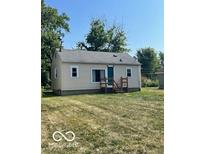 Ranch style house with a green door and yard at 304 Andover Rd, Anderson, IN 46013