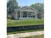 Charming single story home with a covered front porch and an American flag at 217 Ringwood Way, Anderson, IN 46013