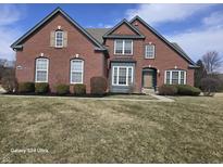 Charming two-story brick home with manicured landscaping and a classic architectural design at 10870 Picket Fence Pl, Fishers, IN 46037