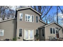 Charming two-story home with white-framed windows and neutral siding with a sunny blue sky at 7934 S 600 W, Edinburgh, IN 46124