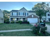 Two story house with brick and siding, attached garage, and landscaping at 6808 Senators Dr, Indianapolis, IN 46217