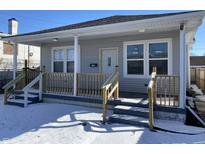 Charming home featuring new wooden porch, neutral siding, and freshly painted stairs, perfect for a cozy retreat at 2729 Massachusetts Ave, Indianapolis, IN 46218