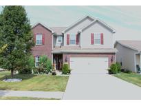 Charming two-story home with a well-manicured lawn and a two car garage at 882 Brookshire Dr, Franklin, IN 46131