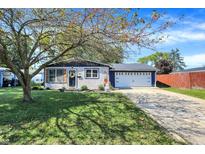 Charming single-story home featuring a two-car garage and a well-manicured lawn at 604 Delbrook Dr, New Whiteland, IN 46184