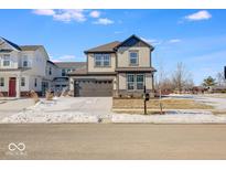 Two-story home with gray siding, stone accents, and a two-car garage at 7426 Cella Ln, McCordsville, IN 46055