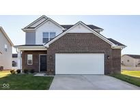 Two-story brick home with a white garage door and landscaping at 222 Winding Brook Way, Pendleton, IN 46064
