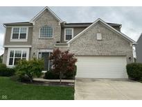 Two story home with a white garage door and landscaping at 1297 Vista Way, Greenwood, IN 46143
