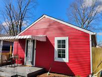 Charming red home with awning-covered porch and white trim at 1504 Martin St, Indianapolis, IN 46227