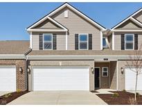 Charming townhome featuring a two-car garage, neutral siding, and classic black shutters at 6286 Wasco Dr, Whitestown, IN 46075
