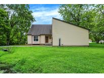 Charming home featuring well-maintained siding, manicured lawn, and a tranquil water feature at 2747 E Midland Rd, Indianapolis, IN 46227
