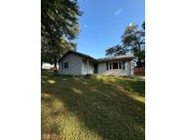 Charming single-story home with a well-maintained lawn and mature trees under a clear blue sky at 8855 N Waverly Park Rd, Martinsville, IN 46151