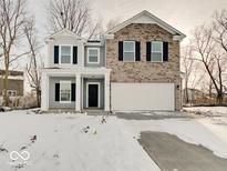 Charming two-story home featuring a two-car garage and a welcoming front porch at 3567 Windstar Ct, Columbus, IN 47203