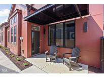 Inviting front porch with modern chairs and sleek black awning, enhancing curb appeal at 1676 Solebar Way, Westfield, IN 46074