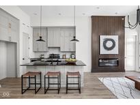 Modern kitchen with sleek black countertops, gray cabinetry, and a cozy breakfast bar at 1676 Solebar Way, Westfield, IN 46074