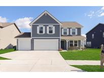 Beautiful two-story home with a three-car garage, well-manicured lawn, and a charming front porch at 1130 Cobra Dr, Franklin, IN 46131
