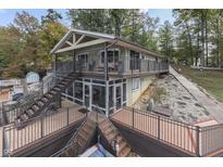 Two-story lakefront home with large deck and multi-level patio at 7438 Haw Dr, Nineveh, IN 46164