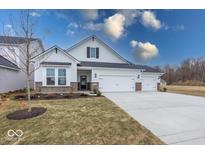 Charming two-story home featuring a three-car garage, brick accents, and a well-maintained lawn at 4979 Elaine Ct, Noblesville, IN 46062