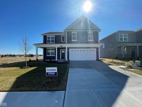 Two-story home with a well-manicured lawn and a two-car garage at 1537 Hanover St, Danville, IN 46122