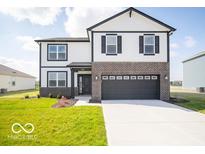 Charming two-story home with a two-car garage, brick accents, and a well-manicured lawn at 140 Velvet Hat Rd, Danville, IN 46122