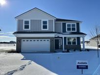 Charming two-story home featuring a two-car garage and covered front porch on a snow-covered lot at 146 Velvet Hat Rd, Danville, IN 46122