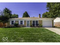 Charming single-story home with a well-manicured lawn and a classic brick facade at 1336 Arcola Ct, Beech Grove, IN 46107