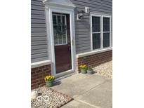 Charming front entrance featuring a wreath and flower pots at 511 Fayette Dr, Westfield, IN 46074