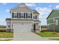 Traditional two-story home featuring gray siding, black shutters, a two-car garage, and a well-manicured lawn at 2260 Marjorie Way, Shelbyville, IN 46176