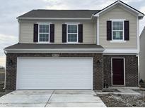 Charming two-story home featuring a brick facade, neutral siding, and a two-car garage at 2910 Strauss Ln, Indianapolis, IN 46239