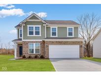 New two-story home boasting brick and green shingle siding, plus an attached two car garage at 4832 E Shadowbrook Dr, Camby, IN 46113
