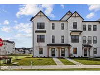 Charming new construction townhome with crisp white siding, black trim, covered entry, and well-manicured lawn at 4231 Barrel Ln, Westfield, IN 46062
