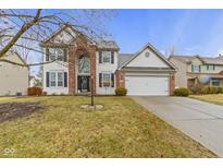 Charming two-story home featuring a well-manicured lawn and attached two-car garage at 10476 Prairie Fox Dr, Fishers, IN 46037