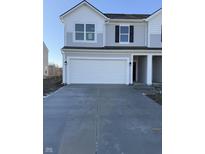 Charming two-story home with attached two-car garage, featuring a long driveway for convenient parking at 10835 Penwell Way, Indianapolis, IN 46235