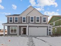 Two-story home with gray siding, white trim, covered porch, and two-car garage, set against a blue sky at 9971 Redwood Peak Ln, Indianapolis, IN 46259