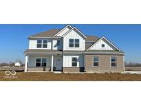 Charming new construction two-story home with brick accents and a well-lit front porch at 7856 Magnolia St, New Palestine, IN 46163