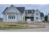 An exterior view of a new construction two-story home with light blue siding and a dark roof at 1717 Beaufain St, Carmel, IN 46032