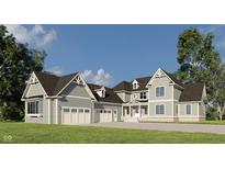 Stunning two-story home with a three-car garage, gray siding and a beautifully landscaped front yard at 1717 Beaufain St, Carmel, IN 46032
