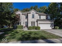 Two-story brick home with a landscaped lawn and attached garage at 3584 Inverness Blvd, Carmel, IN 46032