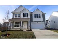 Two-story home with gray siding, white accents, and a stone facade at 16799 Cheddar Dr, Noblesville, IN 46060