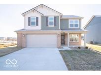 Charming two-story home with attached two car garage and a well-manicured front yard at 6123 Card Blvd, Indianapolis, IN 46221